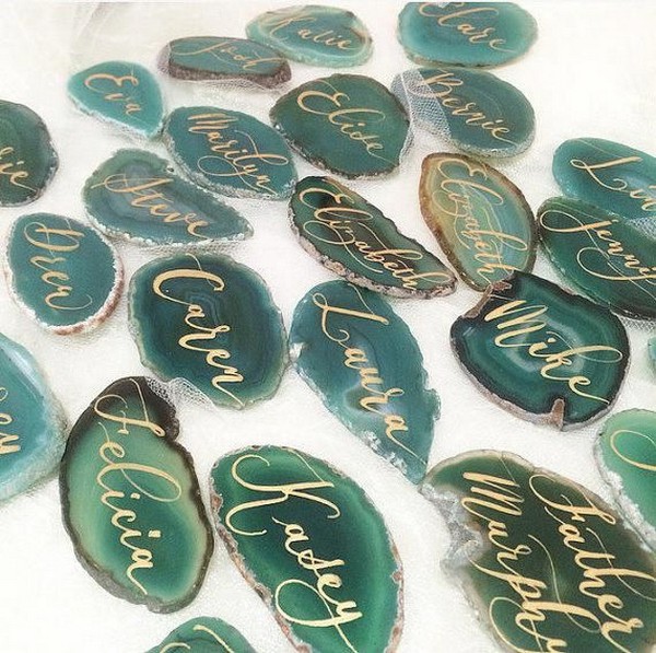 Modern calligraphy written on a natural slice of agate for escort cards