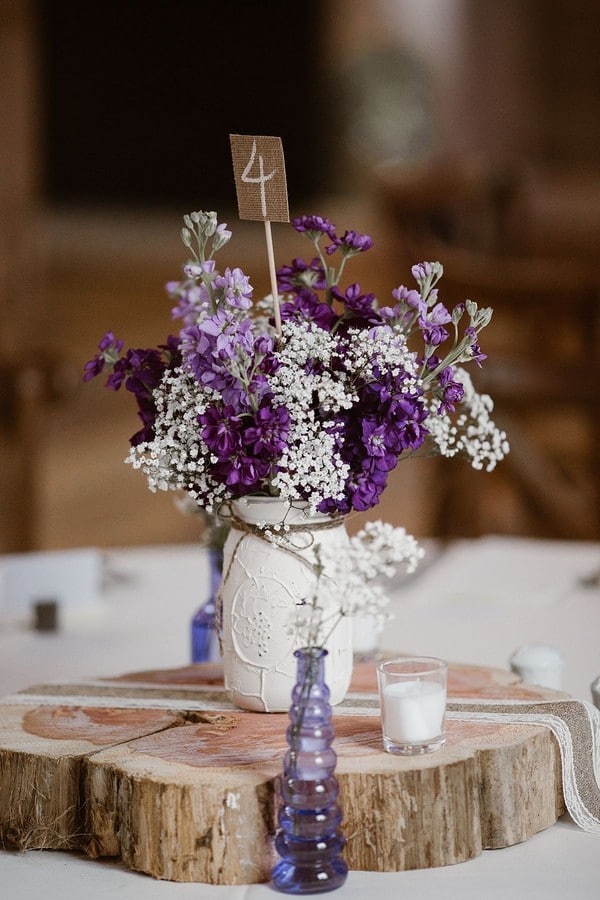 lavender and babys breath and tree stump wedding centerpiece ideas