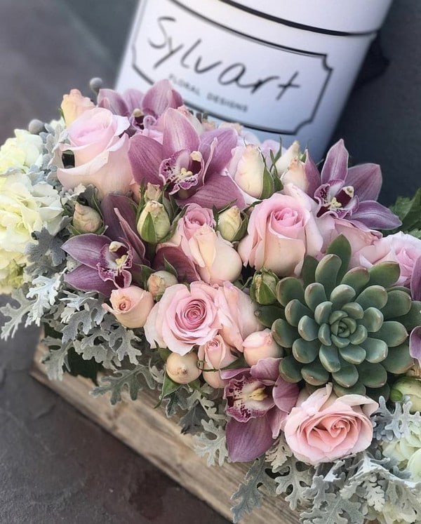 mauve pink flowers with succulent wedding centerpiece