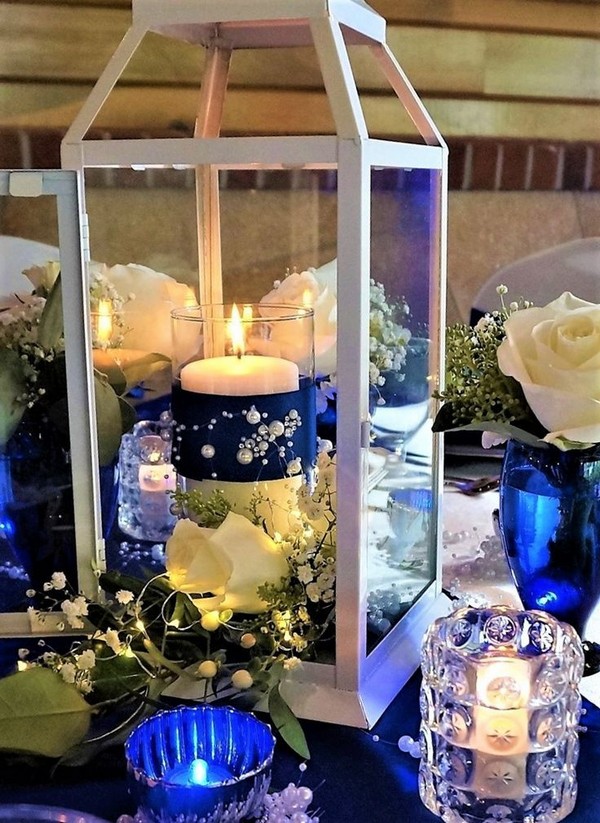 Modern Vintage Lantern Centerpiece with fresh flowers and royal blue embellishments