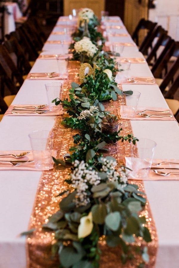 Wedding rose gold table runner with ivory garland down the middle