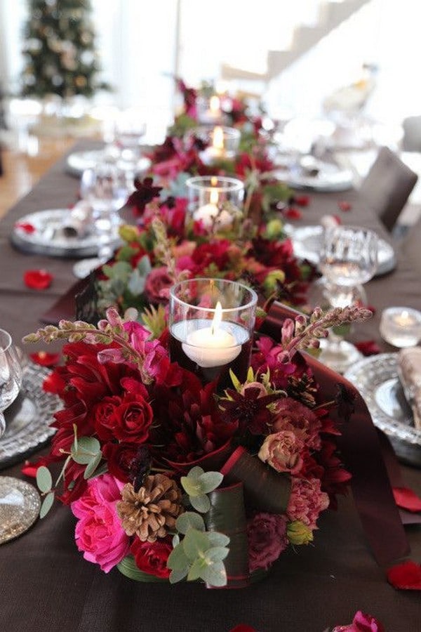 burgundy flowers around candles wedding centerpiece
