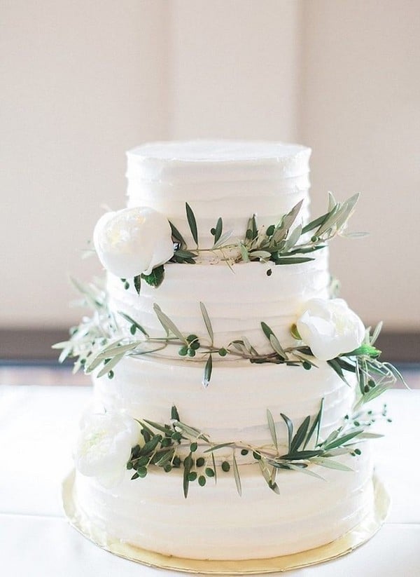 simple greens and white flowers white tiered wedding cake