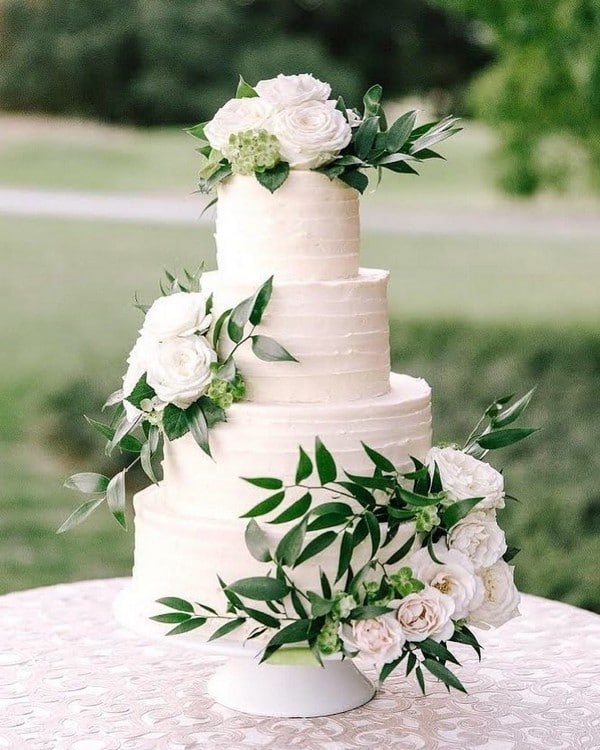 white and greenery buttercream wedding cake 27