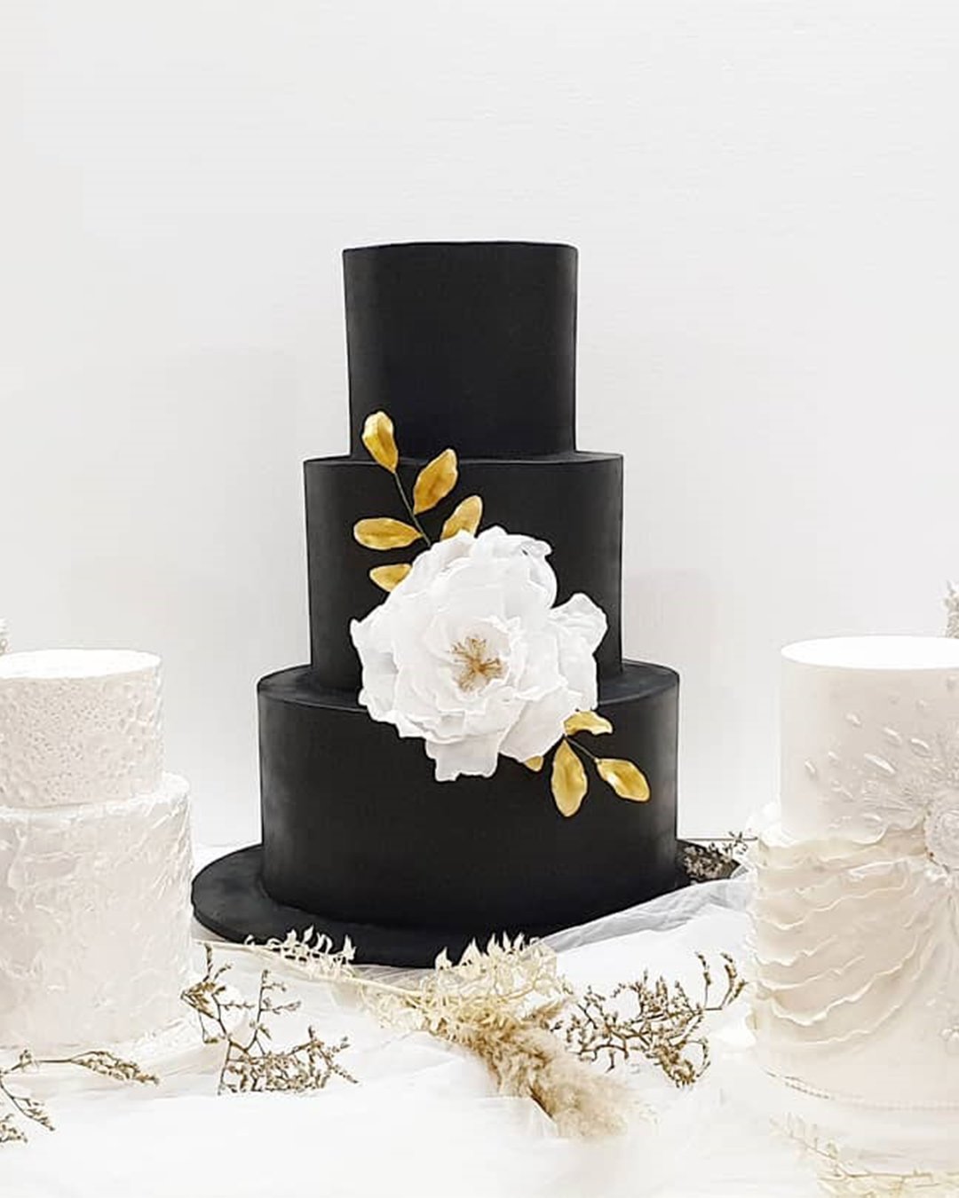 simple elegant black wedding cake with white flowers