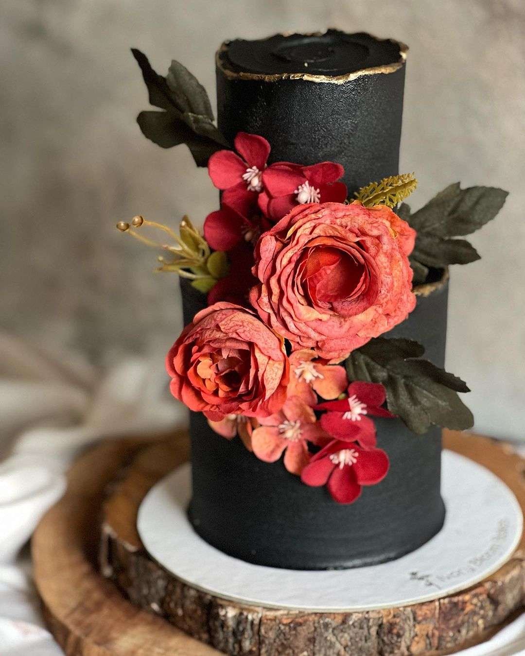 matte black wedding cake with red flowers via ivorybloombakes