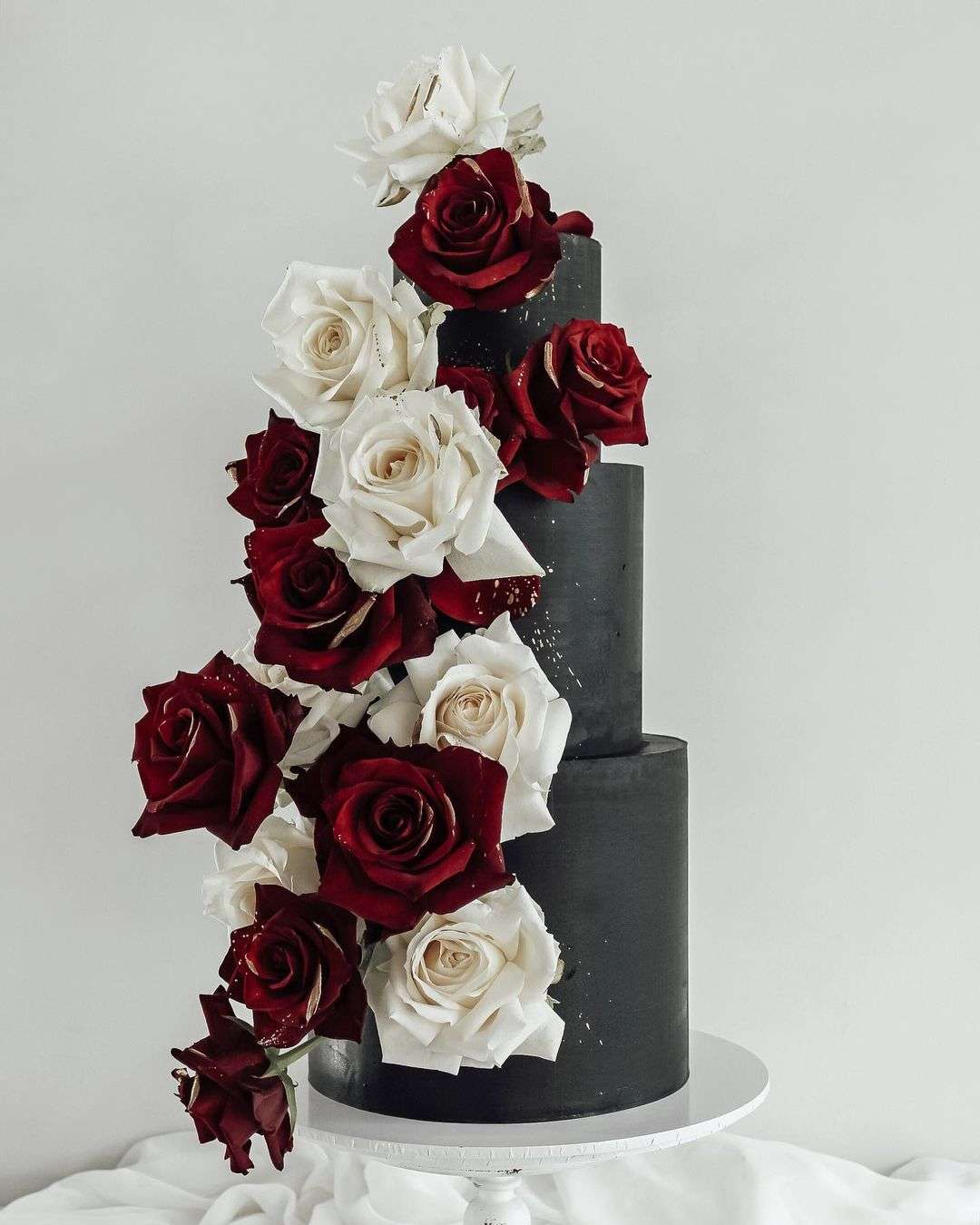 moder black wedding cakes with red and white roses via sincerelysamcakes
