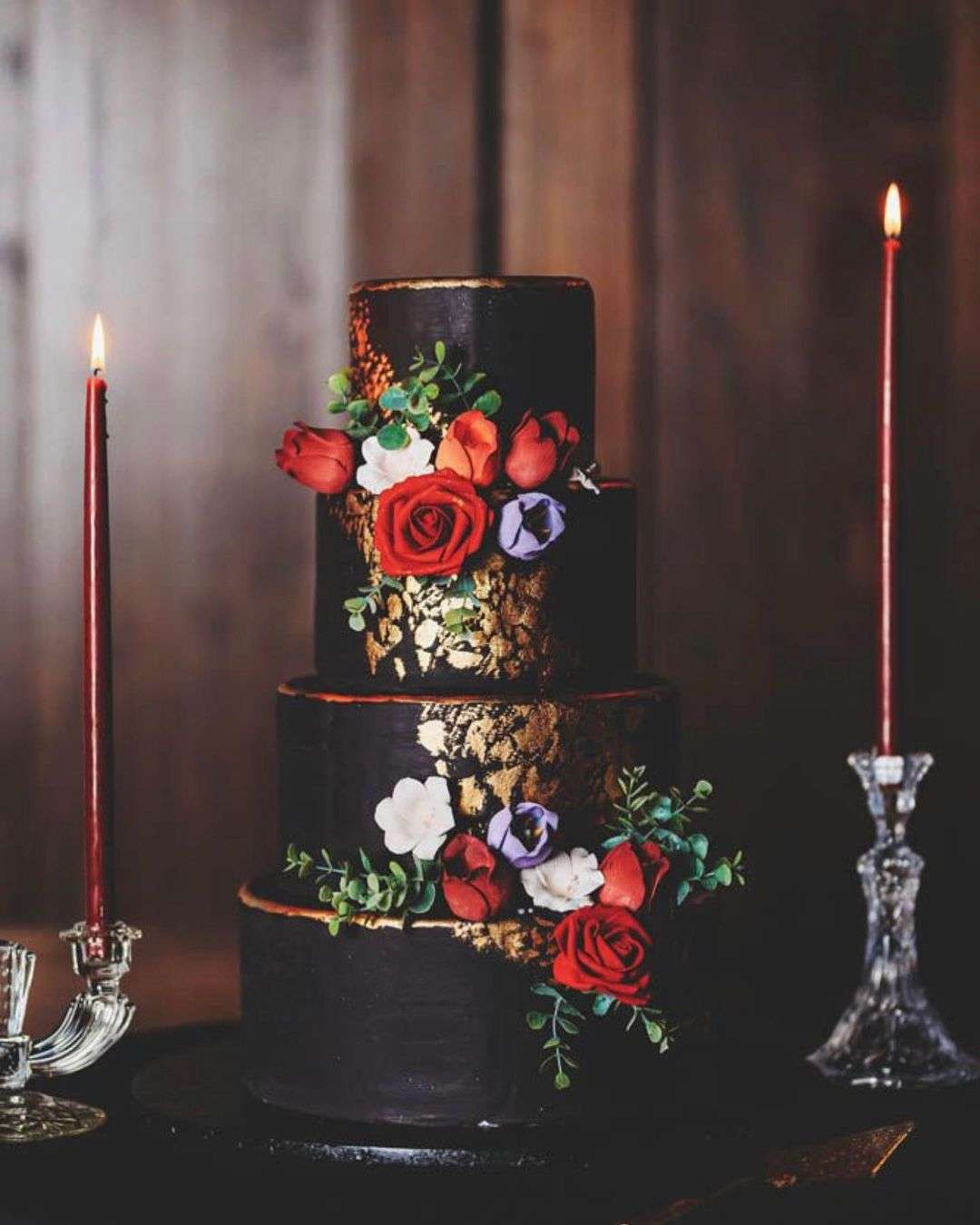 vintage gold and black wedding cake with red flowers via theweddingmag